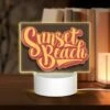 Rectangular Acrylic Night Light, A Sunset Beach Sign With Yellow Letters.