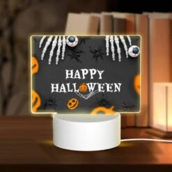 Rectangular Acrylic Night Light, A Halloween Poster With A Spider Web And Skeletons.