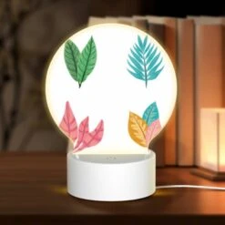 Round Acrylic Night Light, Four Different Colored Leaves Are Shown In A Row.