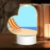 Love Acrylic Night Light, A Colorful Beach Chair Is Sitting On A Sandy Beach.