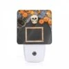 Night Light, A Black Frame With A Skull And Pumpkins In The Background.