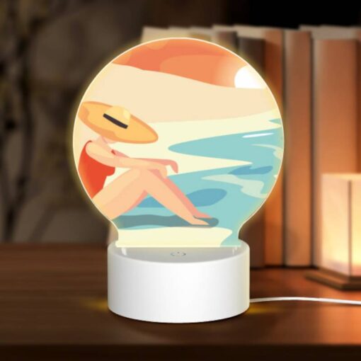 Round Acrylic Night Light, A Woman Wearing A Hat Sits On The Beach. -Acrylic Night Light Shop 559bcb805aa374d3fbf2721e66d5012a00490813