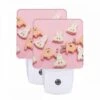 Night Light Set Of 2, A Pink Background With A Bunch Of Halloween Cookies.