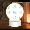 Round Acrylic Night Light, Six Different Types Of Plants Are Shown In A Row.
