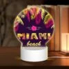 Round Acrylic Night Light, A Colorful Beach Scene With Palm Trees And The Word "Miami" Written In Yellow.