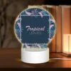 Round Acrylic Night Light, A Tropical Leaves Design With A Pink And Blue Color Scheme.