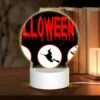Round Acrylic Night Light, A Halloween Sign With Four Different Images Of Witches And Bats.