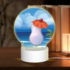 Round Acrylic Night Light, A Cocktail With A Cherry On Top Is Sitting On A Beach.
