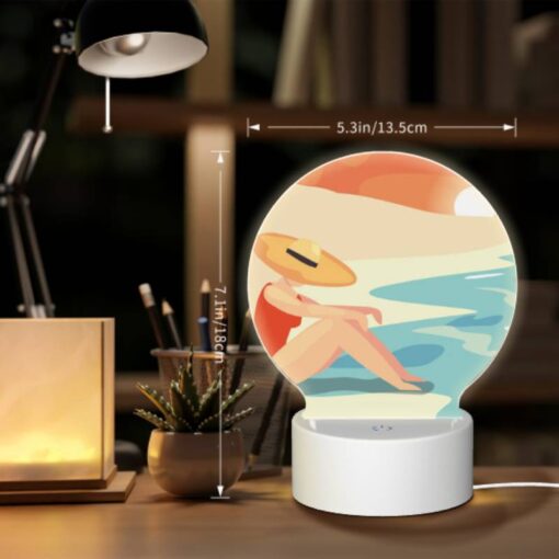 Round Acrylic Night Light, A Woman Wearing A Hat Sits On The Beach. -Acrylic Night Light Shop d4420bc15b282f95c63cb4da346638e14d137231