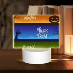 Rectangular Acrylic Night Light, A Colorful Halloween Banner With The Words "Happy Halloween" And "Trick Or Treat" Written On It.