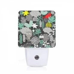 Night Light, A Black And White Image Of A Bird Sitting On A Branch Surrounded By Green Leaves.