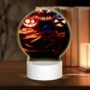 Round Acrylic Night Light, Three Pumpkins With Faces Carved Into Them Are Sitting On A Table.
