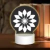 Round Acrylic Night Light, A Black And White Flower Design.