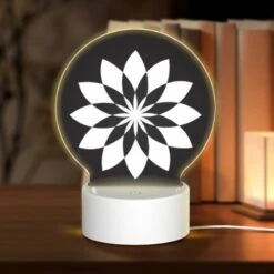 Round Acrylic Night Light, A Black And White Flower Design.