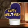 Love Acrylic Night Light, A Purple Background With A Skull And Crossbones And The Words "Happy Halloween" Written In Yellow.